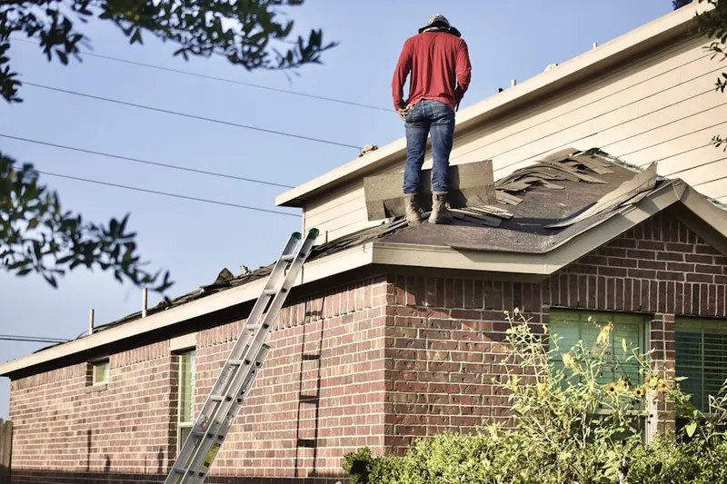 Professional roofer working on a residential roof in East Boxwood Estates
